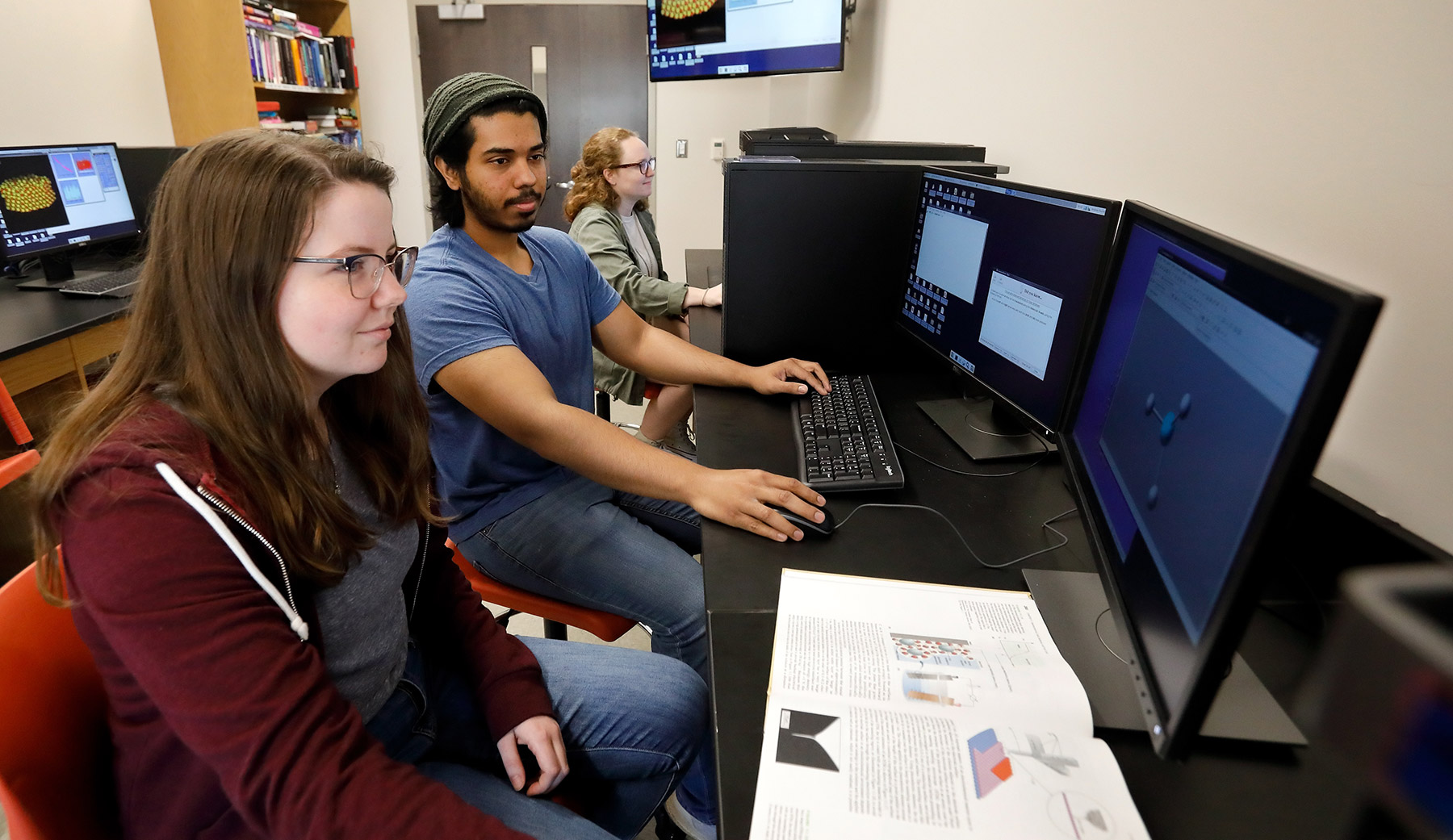 Two students sitting in front of a computer